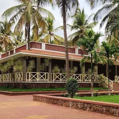 My philosophy is to work with nature, not against it. At the 'Grid in the Grove' farmhouse, the entire design was built around the existing coconut grove, creating a rustic, Hampi-inspired retreat that feels completely integrated with its surroundings.