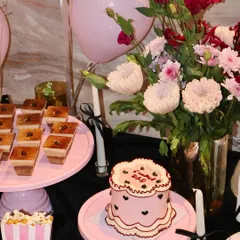 This is how we do home hosting. A beautiful dessert table we curated, featuring one of our vintage cakes alongside other sweet and savory bites.