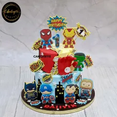 For the little superhero in your life, this two-tier Avengers-themed cake is packed with action. It features edible images of Spiderman, Iron Man, Hulk, and Captain America against a city skyline, complete with comic book sound effects like 'POW!' and 'BAM!'.