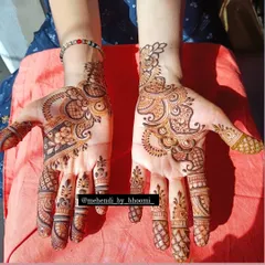 A stunning Arabic mehendi design that covers both hands. The patterns are bold and interconnected, creating a striking look that is both modern and traditional.