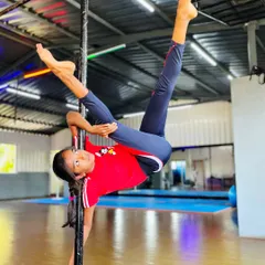 Defying gravity with grace and power. This incredible split on the pole is a testament to the strength, flexibility, and dedication our students develop. We guide each child to safely achieve amazing feats of pole fitness.