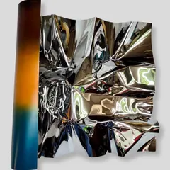 I call this series 'Meteor,' where I work to make rigid stainless steel feel fluid and alive. This wall installation, Meteor 151, uses a color gradient to capture the warmth of a sunset, with the polished surface constantly playing with light and reflection.
