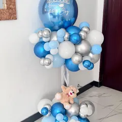 A grand welcome for a little boy. This large balloon standee in shades of blue, white, and silver is a fantastic decoration for a welcome home party or a baby shower. It even has a little teddy bear tucked in.