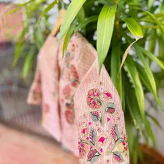 A detailed shot of the sleeve of our pink Kalamkari patchwork blouse, showing the intricate floral embroidery.