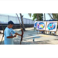 We mix serious practice with fun challenges. This student is taking aim at our balloon-popping targets, a camp favorite that helps improve accuracy under pressure.