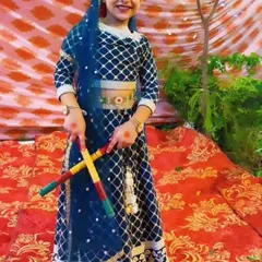 Our little Radha, ready for the dandiya dance with her colorful sticks. We ensure every child gets their moment to shine in our festive productions.