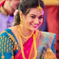 This bride's smile is absolutely infectious. I captured this candid moment during the ceremony, showcasing her genuine happiness and the vibrant colors of her South Indian bridal attire.
