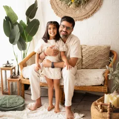 A proud dad with his daughter. This simple and happy portrait captures their close bond in our relaxed, boho-themed studio.