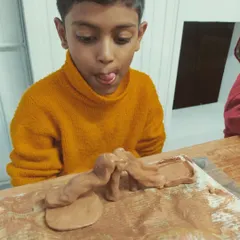 The look of pure concentration and fun! In my "Muddy Puddles" kids workshops, children are free to explore their creativity. These sessions are a wonderful creative outlet after a busy week at school.