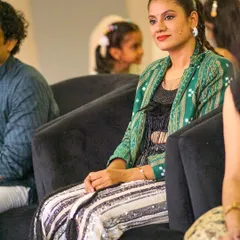 A candid moment watching other performances at an Odia cultural event. I am deeply connected to my roots and love celebrating our rich artistic traditions.