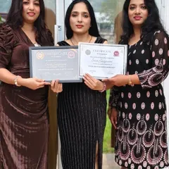 A proud moment as a student receives her professional hair and makeup artist certifications.
