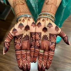 This design with hanging jhumkas (earrings) is very popular for festivals and parties. The dark, rich stain shows the quality of my organic henna.