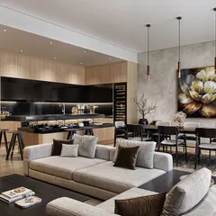 An open-concept luxury living space designed for a client in the USA. This rendering focuses on the interplay of light and texture, from the natural wood paneling and dark stone kitchen island to the soft fabrics of the furniture, creating a warm and inviting atmosphere.