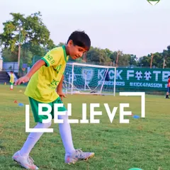 Believe. A young player focuses on the ball, embodying the belief in his own ability that we work to instill in every child.