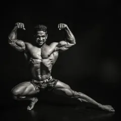 A black and white artistic shot of a classic bodybuilding pose. This highlights the muscle definition, symmetry, and conditioning that I strive for with my clients who are serious about physique development.