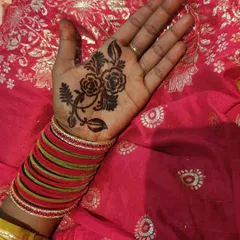 A single, elegant floral motif placed in the center of the palm. This is a perfect example of minimalist henna.
