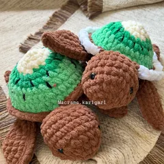 A pair of our kiwi-themed crochet turtles. We use a combination of green, white, and brown chunky yarn to create the look of a real kiwi fruit on their shells. They are soft, squishy, and utterly unique.