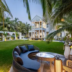 At the Tropical Manor, I designed this circular deck as a serene escape nestled within a grove of coconut palms. The ambient lighting and modern gothic architecture create a mood of grounded grandeur, offering a perfect spot to unwind and connect with nature.
