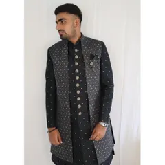 A front view of the grey long jacket and black kurta set. You can see the detailed print on the jacket and the elegant buttons on the kurta, along with a pocket square for a finishing touch. It's a complete, ready-to-wear look.