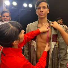 A candid moment from backstage at Lakme Fashion Week, where I'm making a last-minute fitting adjustment on a model for the Huemn show. Styling a runway show is a fast-paced, hands-on process.