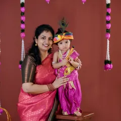 Another beautiful mother and child portrait for a Janmashtami photoshoot. The colorful outfits and traditional decor create a vibrant and culturally rich memory.
