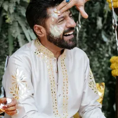 The groom's Haldi begins! A moment of pure laughter and tradition as the turmeric paste is applied, marking the start of the wedding rituals.