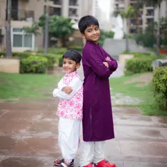 A great portrait of two brothers in traditional Indian wear. This back-to-back pose shows their playful and supportive relationship.
