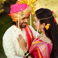 An intimate moment between a couple during their outdoor Maharashtrian traditional shoot. The soft, natural light and lush green background create a romantic atmosphere, showcasing my ability to capture genuine connection.