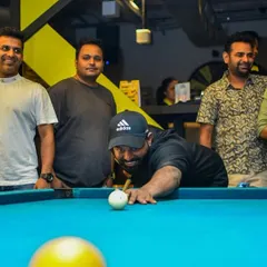 That moment of intense focus before the perfect shot. The pool table is where friendships are tested and champions are made.