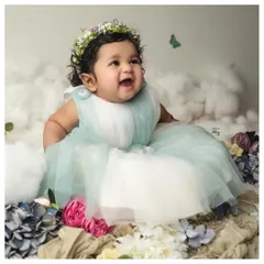 Celebrating six months of pure magic. This little one's happy expression is captured in a dreamy setup with soft clouds and a floral crown. My six-month milestone sessions are designed to showcase your baby's budding personality and those adorable gummy grins.