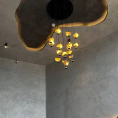 A closer look at the dramatic ceiling detail. The recessed cove lighting follows the custom-designed organic shape, creating a soft glow that highlights the room's unique architecture.