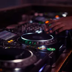 A detailed look at my hand adjusting levels on the console. Mastering the mixer is a core part of my DJ training for beginners and experienced artists alike.