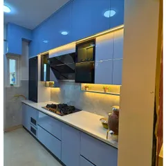 A kitchen should be as beautiful as it is functional. This modern modular kitchen features a cool blue palette, sleek handleless cabinets, and smart under-cabinet lighting, creating an efficient and stylish space for cooking and family time.