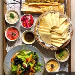 My classic Mezze Platter is a journey to the Mediterranean. It includes creamy, homemade hummus and other dips, crispy falafel, pickled vegetables, fresh salad, and warm pita bread, all arranged and ready to serve.