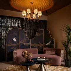 In this zone, we brought together soft mauve, rich mustard, and deep midnight blue to create a feeling of quiet opulence. The custom-designed curved sofa and the intricately embroidered fabric partition are bespoke pieces that define the character of this intimate lounge area within the retail space.