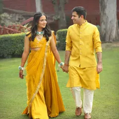 A sweet and simple portrait from a Haldi function. The couple holds hands and shares a look, dressed in beautiful shades of yellow, perfectly matching the theme of the day.