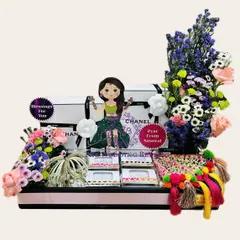 Another view of our beautiful Teej hamper, featuring a cute caricature, fresh flowers, and traditional elements like parandis.