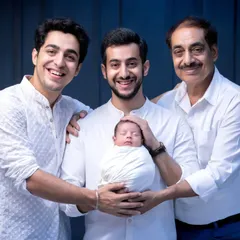 Four generations of men in one photo. The great-grandfather, grandfather, and new father all gathered around the family's newest addition. This is a powerful and priceless heirloom portrait.