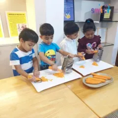 Our children work together to prepare a healthy snack, grating carrots for a tricolour salad. This practical life exercise teaches them valuable kitchen skills, promotes teamwork, and develops their fine motor coordination.