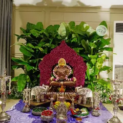 A customized backdrop for a Varamahalakshmi pooja for one of my oldest clients. The goddess is framed by a halo of carnations, with a lush background of banana leaves and silver elephant props.