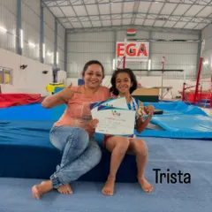 Trista celebrating her well-deserved medal at the VIBGYOR Viva Competition. We support each gymnast's individual journey to success.