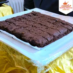 No meal is complete without dessert. Here is a tray of our rich and fudgy chocolate brownies, cut into bite-sized pieces and ready to be served at a wedding reception.