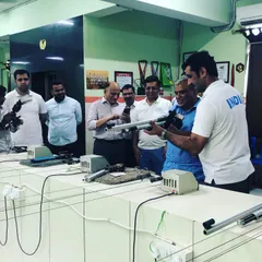 Explaining the mechanics of an air rifle to an interested group. These sessions are not just about shooting, but also about learning and appreciating the sport.