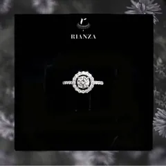 A classic choice for a lifetime promise, this is a custom-made round solitaire engagement ring surrounded by a brilliant halo of smaller diamonds. I work with clients to create the perfect symbol of their love story.