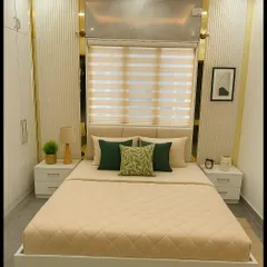 This modern contemporary bedroom from a 3BHK project in Bannerghatta showcases our skill in blending minimalism with luxury. We used a palette of soft neutrals and gold accents, complemented by grooved wall panels, high-gloss wardrobes, and warm cove lighting to create a cozy yet sophisticated space.