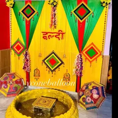Here is a classic Haldi decor setup I did for a home ceremony. I used bright yellow and green drapes, traditional hangings, and a central low seating area with a decorated chowki inside a large urli, perfect for the rituals.