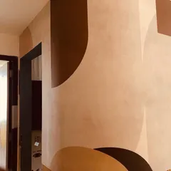 A side view of the abstract geometric mural, showing how the design flows seamlessly from the curved section to the flat wall.