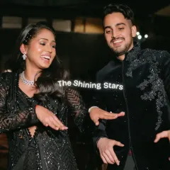 The couple shows off their coordinated dance moves during their Sangeet performance. Their sparkling black outfits perfectly match the glamorous and starry theme of the night.