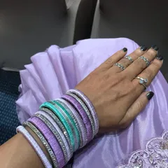 A full view of the custom silk thread bangle set on my arm. The combination of lavender, purple, and turquoise with stone-studded bangles creates a rich, festive look.