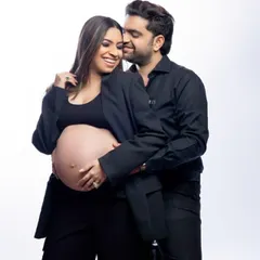 Partnering in parenthood with style. We love this power couple look, with both partners rocking black suits. It's a chic, modern, and confident way to celebrate your journey together.